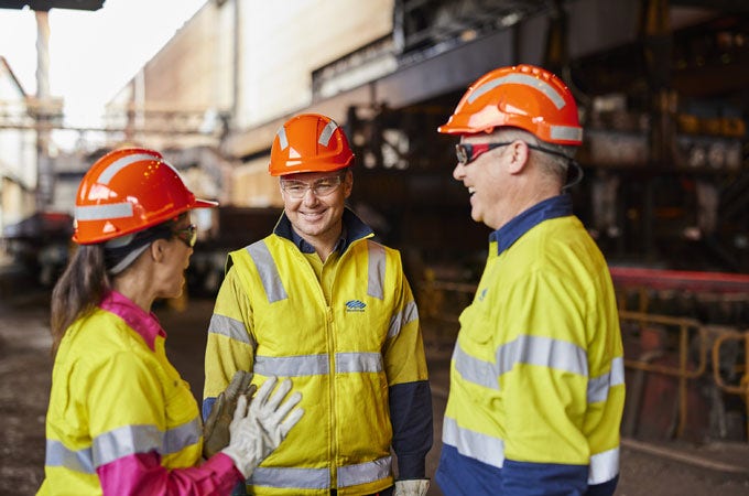 Three BlueScope employees in PPE uniform at Port Kembla Steelworks